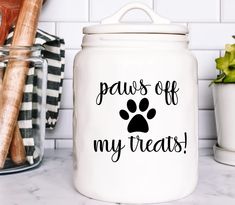 a white canister with paws off my treats on it