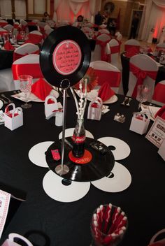 a black and white table topped with lots of red and white decorations