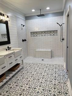 a bathroom with white tile and black accents