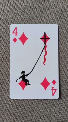 a playing card with an image of a person holding a string attached to the back of it