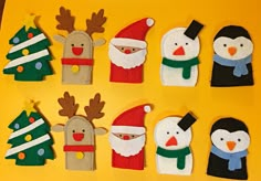 christmas decorations made out of felt with penguins and snowmen in the middle on a yellow background