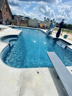 an empty swimming pool with a slide in the middle and water running down it's sides