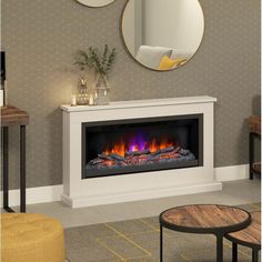 a white fireplace with a mirror above it