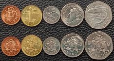 five different types of coins on a black surface