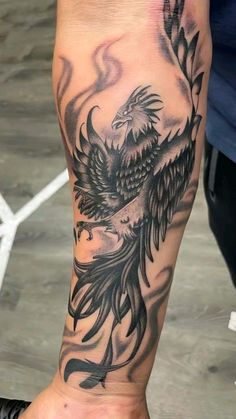 an eagle tattoo on the leg of a person's foot, with black and grey ink