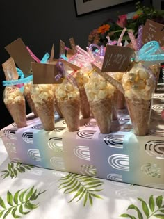 popcorn cones are lined up on a table