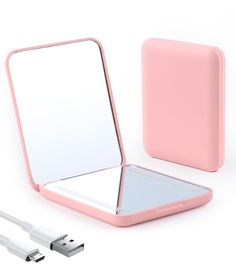 an electronic device with a pink case and charger next to it on a white surface