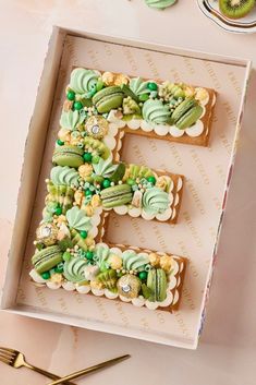 the letter e is made out of cookies and decorated with green icing on top