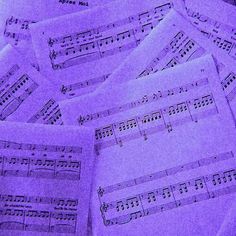 a pile of sheet music sitting on top of a table