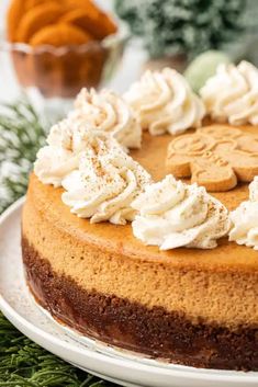 a close up of a cake on a plate with frosting and cookies around it