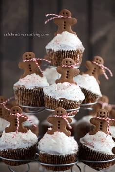 cupcakes decorated with gingerbread and white frosting are arranged on a cake stand