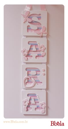 three tags with letters and flowers on them