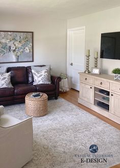 a living room filled with furniture and a flat screen tv on top of a wooden cabinet