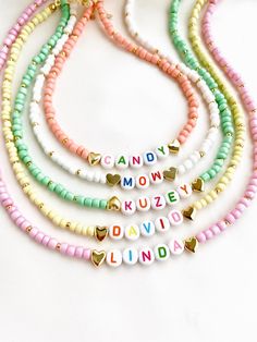 "Welcome to our vibrant and joyful personalized name necklace collection! Our colorful necklaces are perfect for children and make for a wonderful kids' birthday gift, designed to bring smiles to their faces. With six stunning color options to choose from, each necklace is a unique masterpiece. Crafted with colorful beads and adorned with Mother of Pearl letters that spell out a custom name, these necklaces are truly one of a kind. Make your little one's day special by gifting them a personalized name necklace that reflects their unique personality and style. Whether it's for a birthday, a special occasion, or just to show your love, these necklaces are sure to be cherished keepsakes.\" HOW TO ORDER ? 1- Choose the letter quantity of the name/word/phrase/initials you want. 2- Find the righ Trendy Personalized White Charm Necklaces, Trendy White Personalized Necklace, Trendy Personalized Necklaces For Gifts, Trendy Customized Necklaces For Personalized Gift, Trendy Personalized Necklaces For Personalized Gifts, Trendy Personalized Necklace For Personalized Gift, Handmade White Charm Necklaces For Birthday Gift, Cute Personalized Multicolor Charm Necklaces, Trendy Custom Name Necklace For Personalized Gift