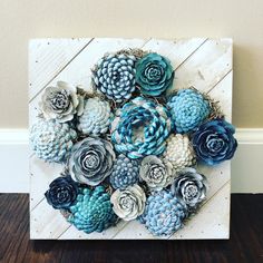 a painting with blue and white flowers in it on a wooden paneled wall next to a wood floor