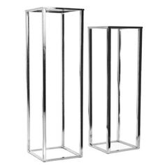 two tall metal vases sitting next to each other on a white background, one is empty