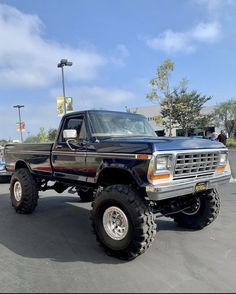 a large black truck parked in a parking lot