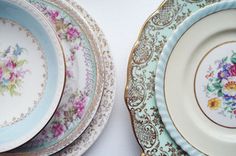 an assortment of china plates with flowers painted on them