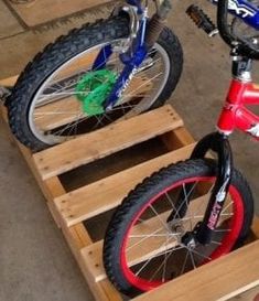 two children's bikes sitting on wooden pallets