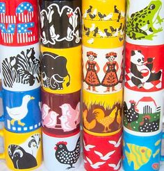 many different colored cups with animals on them