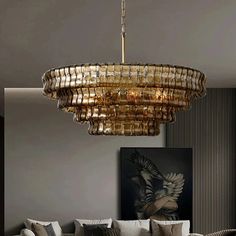 a living room filled with furniture and a large chandelier hanging from the ceiling