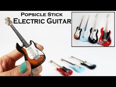 miniature electric guitar being held in front of the camera