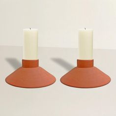 two candles sitting on top of each other