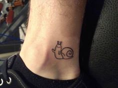 a small snail tattoo on the ankle