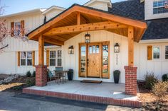 a white house with wood trim and windows