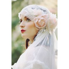 a woman wearing a veil and flower in her hair