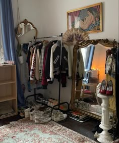 a room with a mirror, clothes rack and shoes