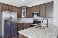 a kitchen with granite counter tops and stainless steel appliances