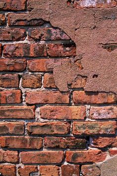 an old brick wall with some cracks in it