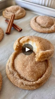 cinnamon sugar cookies on a baking sheet with cinnamon sticks