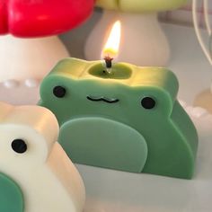 two small candles with faces on them sitting next to each other in the shape of animals