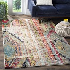 a living room with a blue couch and colorful rug