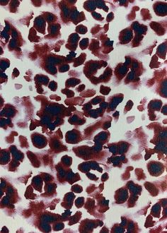 an animal print fabric with red and black spots