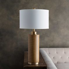 a lamp sitting on top of a table next to a couch