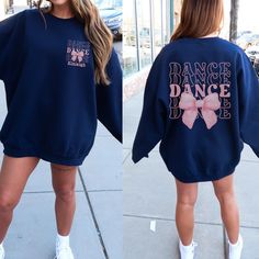 Dance your heart out in style with our "Dance" Sweatshirt featuring a Coquette Bow! 💃🎀 This fashionable and comfortable sweatshirt is perfect for every dancer who loves to add a touch of elegance to their dancewear. Featuring the word "Dance" paired with a cute coquette bow, this sweatshirt is the ideal way to celebrate your passion for dance with flair. 🎨 Vibrant and Trendy Colors: Available in a variety of fashionable colors, this sweatshirt is designed to match your style. Choose your favo Winter Long Sleeve Tops For Cheerleading, Cheerleading Long Sleeve Graphic Print Sweatshirt, Hip Hop Long Sleeve Sweatshirt For Dance, Casual Tops For Dance In Fall, Casual Tops For Fall Dance, Fall Dance Cotton Sweatshirt, Crew Neck Sweatshirt For Dance In Fall, Casual Letter Print Sweatshirt For Dance, Graphic Print Long Sleeve Tops For Dance