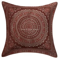 a red pillow with an intricate design on it