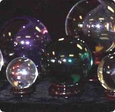 several shiny glass balls sitting on top of a table