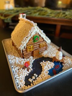 a gingerbread house made to look like it is in the snow