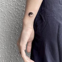 a person with a small tattoo on their arm