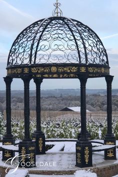 a black and gold gazebo in the snow