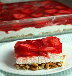 a piece of cake with strawberries and nuts on it sitting on a white plate