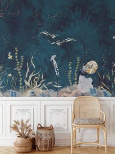 an ocean scene painted on the wall next to a chair and potted plant