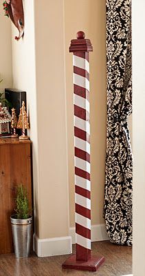 a tall red and white pole in the corner of a room