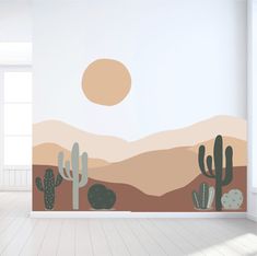 an empty room with cactus and mountains painted on the wall