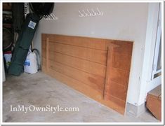 an unfinished garage with wood paneling and bike racks on the wall, along with other items