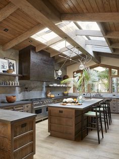 a kitchen with an island and skylights above it